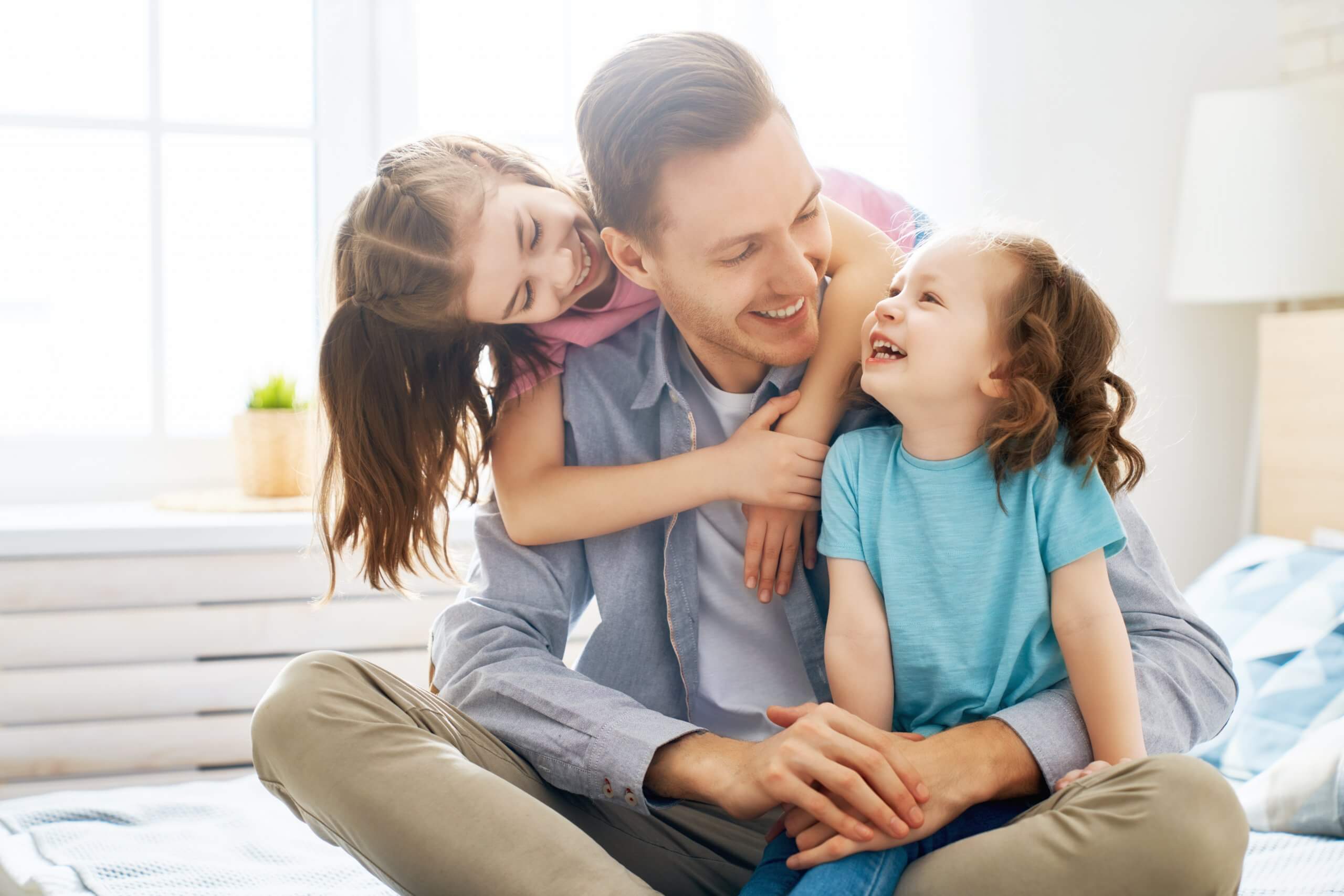 Happy loving family. Daddy and his daughters children girls play